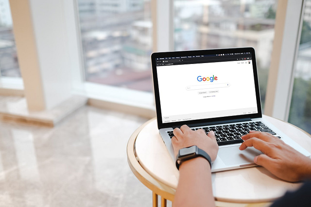 Prioritize your SEO tasks effectively with Hook Agency. Picture this: you're at a sleek, modern table in a bright room overlooking the city skyline. Your laptop is open to the Google homepage. With focus and precision, and aided by your modern smartwatch, optimize your strategy for maximum impact today.